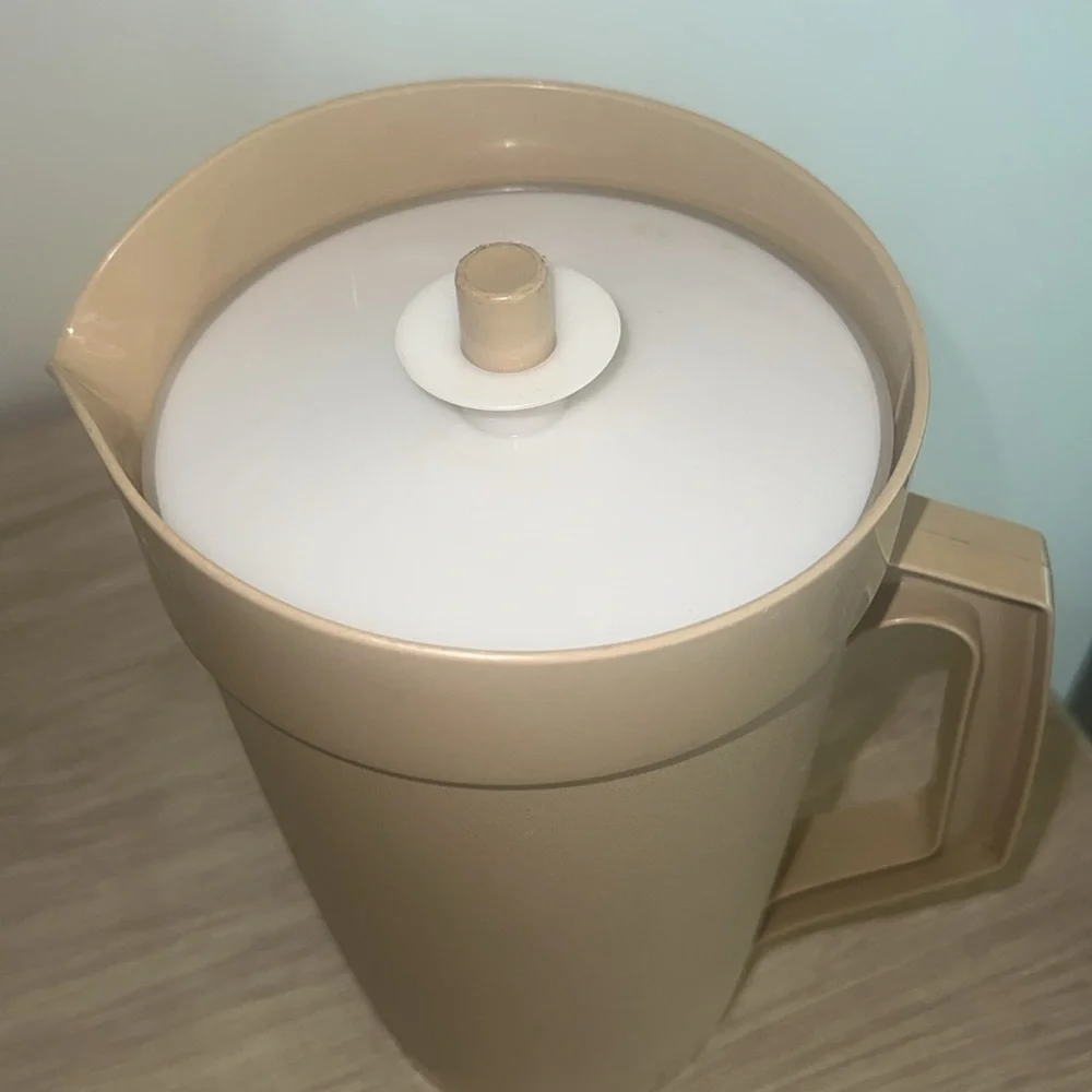 64 oz Vintage Tupperware beige and white pitcher. Looks new. Tight lid.